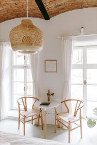 a dining room with a table and two chairs at Apartmány Starák v historickém centru Znojma in Znojmo