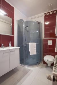 a bathroom with a shower, toilet, and sink at Villa Rosa in Makarska