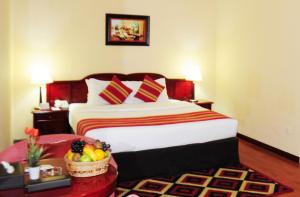 A bed or beds in a room at Fortune Deira Hotel