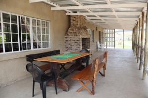 a dining room with a wooden table and benches at Rocks & Roses Farm stay in Lochiel