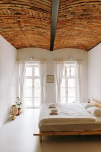 a bedroom with a large bed with a wooden ceiling at Apartmány Starák v historickém centru Znojma in Znojmo