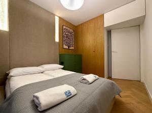 a bedroom with two beds with towels on them at Silver House by Q4Apartments in Gdynia