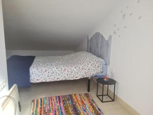 Habitación pequeña con cama y mesa pequeña en Apartamento La alberca 1, en Aracena