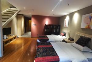 a bedroom with two beds and a living room at Zou Qu Ye Travel Hotel in Chongqing