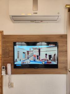 a flat screen tv sitting on top of a wall at Kadıköy White House in Istanbul