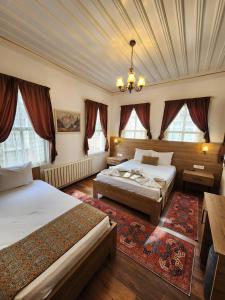 a bedroom with two beds and a ceiling at Kadıköy White House in Istanbul +83 photos