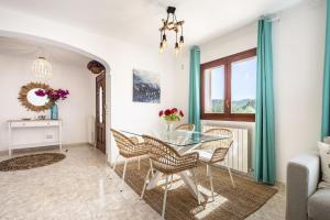 a dining room with a glass table and chairs at Can Prats Country House in Sant Josep de Sa Talaia