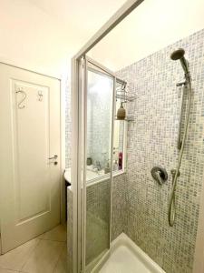 La salle de bains est pourvue d'une douche avec une porte en verre. dans l'établissement Splendido trilocale a due passi dal mare, à Santa Margherita Ligure