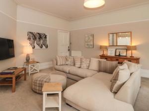 a living room with two couches and a tv at The Anchorage in Bournemouth