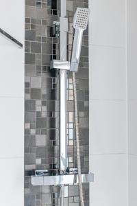 a shower in a bathroom with a shower head at Woodgrange in Southend-on-Sea