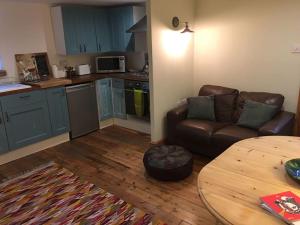 a living room with a couch and a table at The Quirky, cosy hideaway! An apartment close to Leeds City Centre in Amley