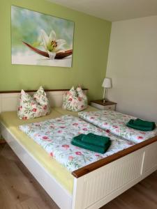 a bed with two pillows on it in a room at Ferienwohnung Claus in Meißen