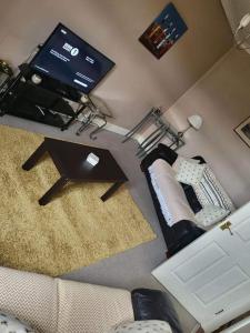 an overhead view of a living room with a couch and a tv at Homely Apartment near the Beach with Mini Luxuries in Methil