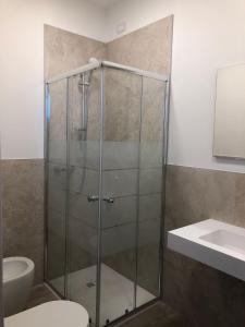 a shower in a bathroom with a toilet and a sink at CASA TERMINEL in Villafranca di Verona