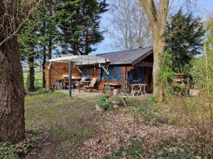 a large wooden cabin with a picnic table in front of it at Chalet in paradise garden in Velden