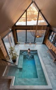 a person in a swimming pool in a house at Skálakot Manor Hotel in Hvolsvöllur