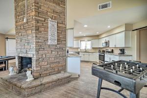a kitchen with a brick fireplace in a living room at Family Friendly Vacation Rental with Gas Grill! in Lake Havasu City