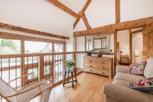 a living room with a couch and a table at Thatch Close Cottages in Ross on Wye