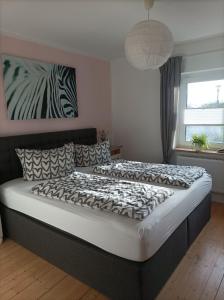 een bed in een slaapkamer met een zebrafoto aan de muur bij Kleine Auszeit in Stakendorf
