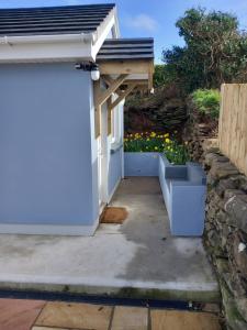 a garage with a retaining wall and a stone wall at River side in Dingle