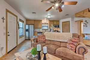 a living room with a couch and a kitchen at Medicine Park Cabin Rental with Mountain View in Medicine Park