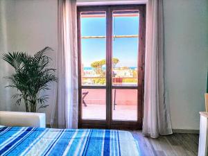 a bedroom with a window with a view of the ocean at Anzio Paradise in Anzio
