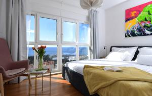 a bedroom with a bed and a large window at CLOUD APARTMENTS DUBROVNIK in Dubrovnik