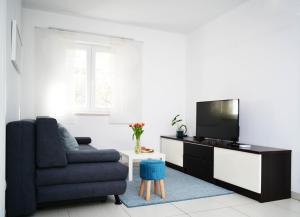 a living room with a couch and a tv at CLOUD APARTMENTS DUBROVNIK in Dubrovnik