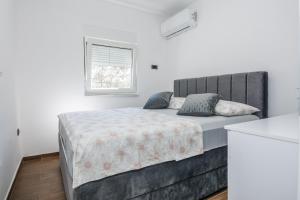 a bedroom with a large bed and a window at Villa Tomic in Vir +18 photos