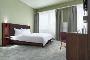 a hotel room with a bed and a chair at b-smart hotel Schönenwerd in Aarau +30 photos