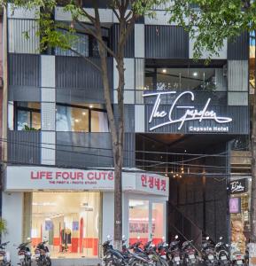 a group of motorcycles parked in front of a building at The Garden Capsule Hotel in Da Nang