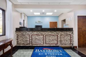 a lobby of a baxter inn with a reception desk at Baymont by Wyndham Midway Tallahassee in Midway