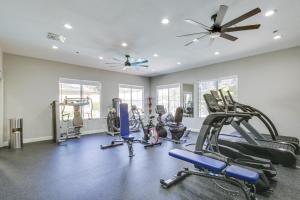 a gym with several tread machines and a ceiling fan at Modern Pet-Friendly San Diego Vacation Rental in San Diego