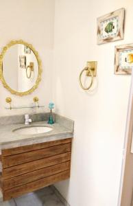 a bathroom with a sink and a mirror at Home suíte taipu in Marau