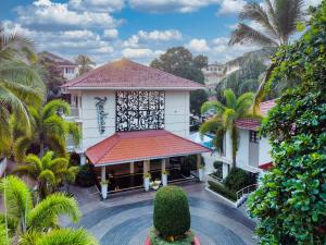 an aerial view of a building with palm trees at Radisson Goa Candolim in Candolim