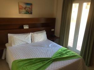 A bed or beds in a room at Hostal San Marcos