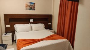 A bed or beds in a room at Hostal San Marcos