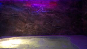 a pool of water with a light shining on it at Discret Hotel & SPA in Vladaya
