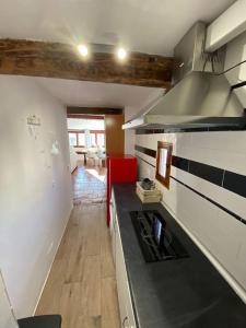 a kitchen with a stove top oven in a room at La alcoba de La Catedral, Apartamento 2-4 pax 3º piso in Cuenca