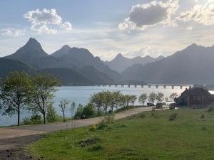 a bridge over a lake with mountains in the background at Siente Riaño in Riaño