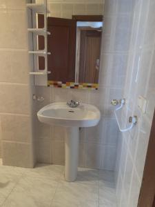 a bathroom with a sink and a mirror at Siente Riaño in Riaño +23 photos