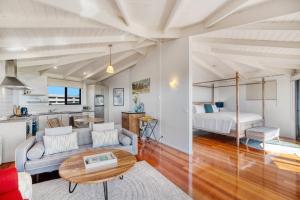 a living room with a couch and a bed at Limosa Rise in Yanakie