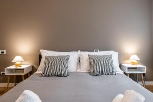 a bedroom with a large bed with two side tables at Maison Marconi in Bologna