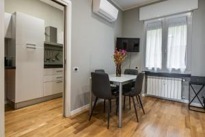 a dining room with a table and chairs and a mirror at Maison Marconi in Bologna +9 photos