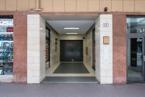 a hallway of a building with a black door at Maison Marconi in Bologna