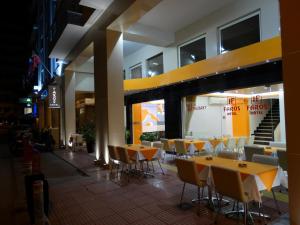 a restaurant with tables and chairs in a building at Faros I in Piraeus