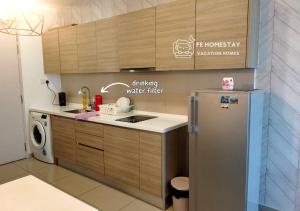 a kitchen with a refrigerator and a washing machine at iCity Homestay 3pax 2BR Theme Park Water World Shah Alam 民宿 by FE Homestay in Shah Alam