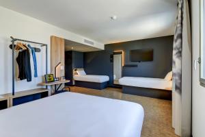 Postel nebo postele na pokoji v ubytování B&B HOTEL Dijon Valmy Toison d'or