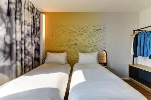Postel nebo postele na pokoji v ubytování B&B HOTEL Dijon Valmy Toison d'or