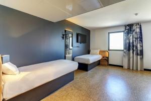 Postel nebo postele na pokoji v ubytování B&B HOTEL Dijon Valmy Toison d'or